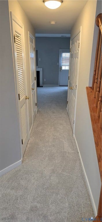 5506 Millwheel Lane, Henrico, VA 23228 Carpeted hallway with painted walls, multiple louvered doors, and a flush mount ceiling light