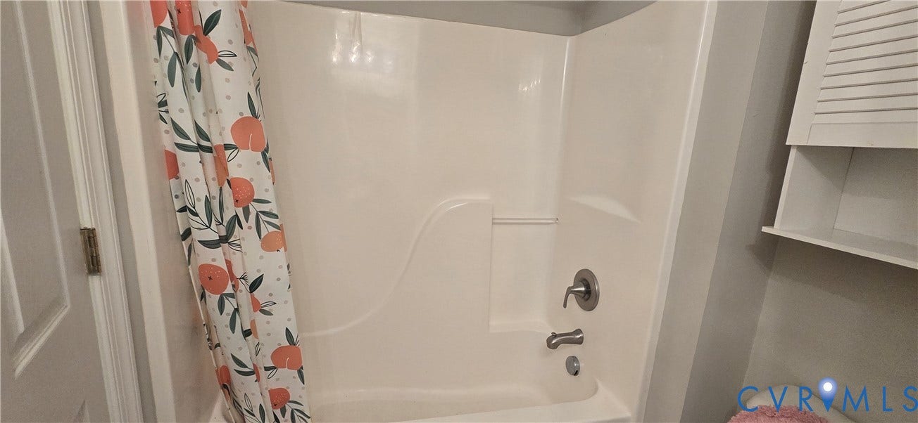 5506 Millwheel Lane, Henrico, VA 23228 White shower/tub combination with integrated shelving