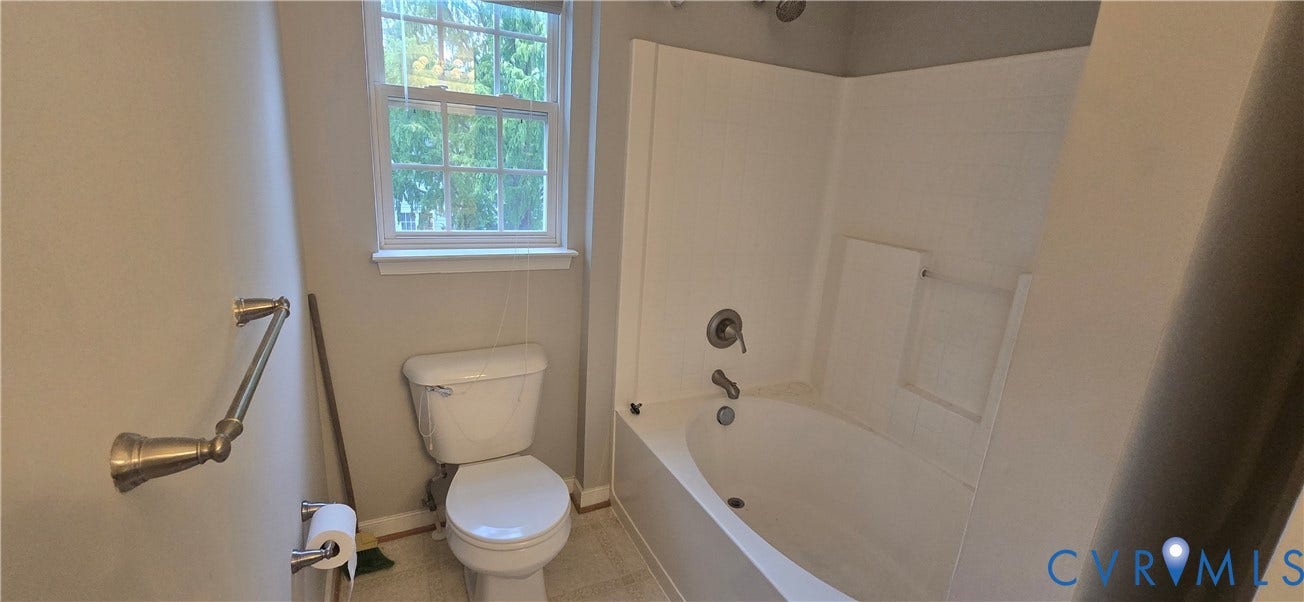 5506 Millwheel Lane, Henrico, VA 23228 Full bathroom featuring a window, white toilet, and a white tub with shower