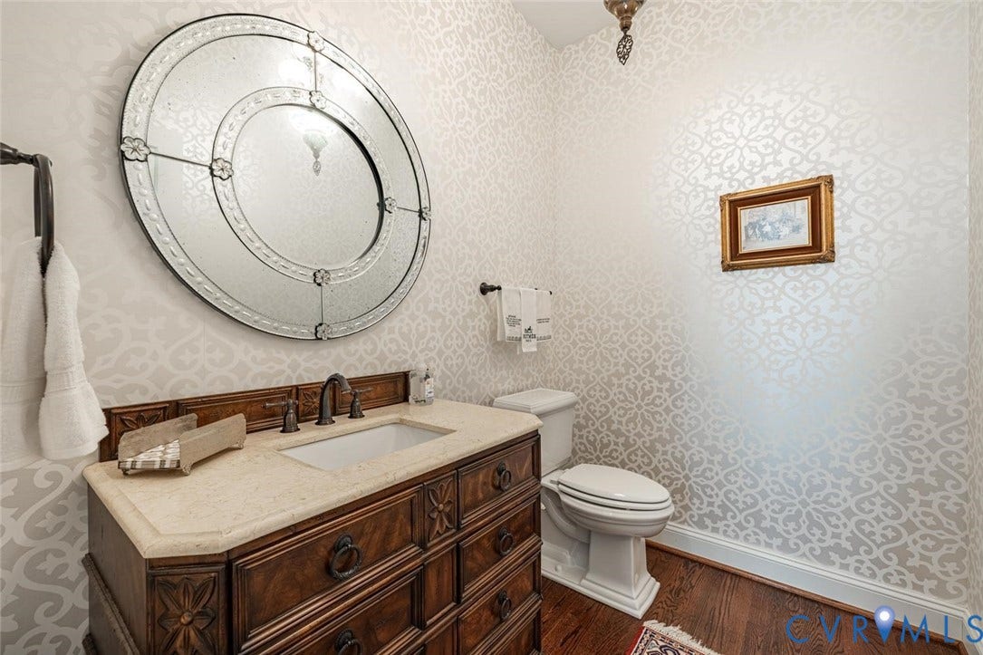 Powder room near the Living Room wiht pretty wallpaper