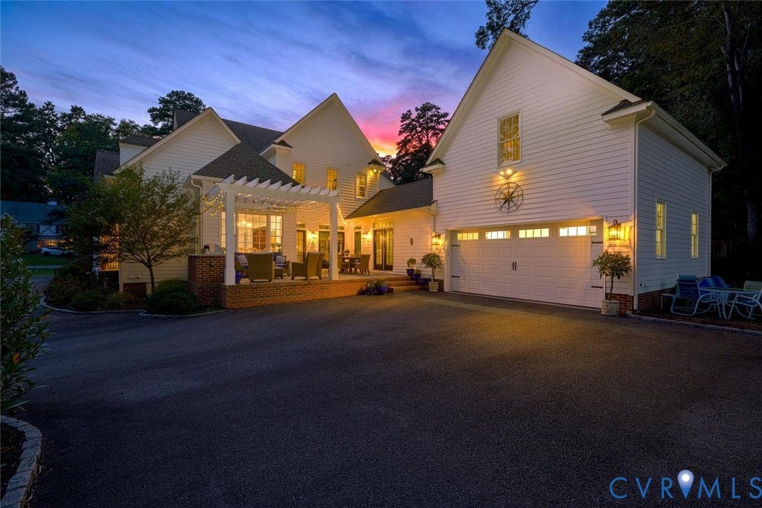 View of patio and 2 car garage