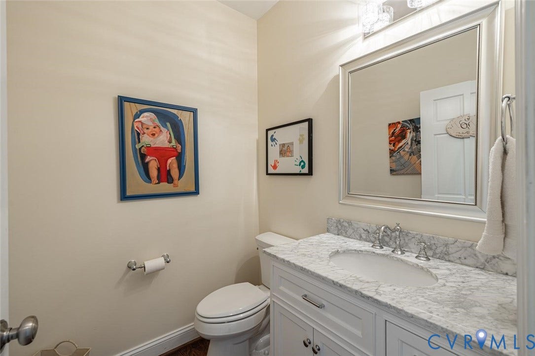 Powder room off of side mudroom & near office