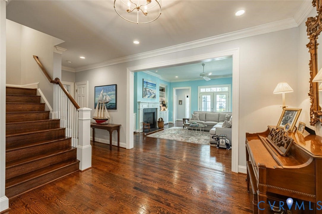 Central Foyer leads to Living Room and holds staircase