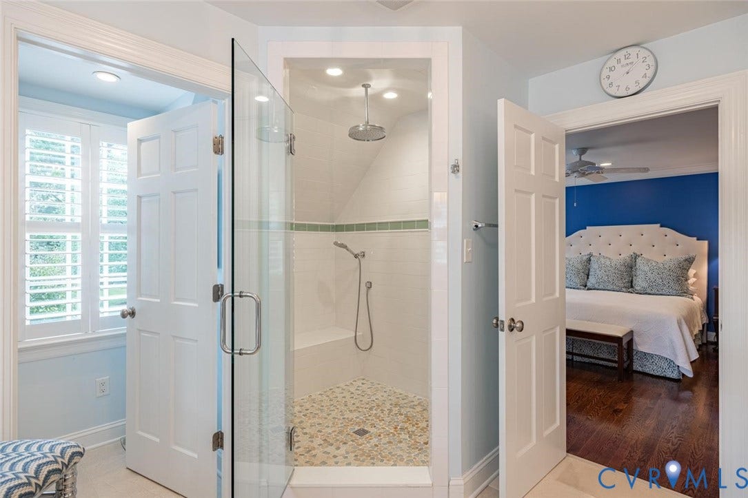Shower with pebble and sea glass floor, subway tile