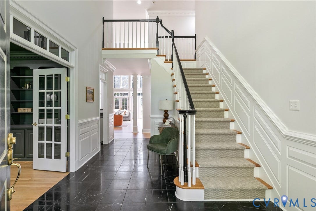 2621 Glenalmond Court, Powhatan, VA 23139 Foyer with dark tile flooring, a carpeted staircase with wood treads, and white wainscoting