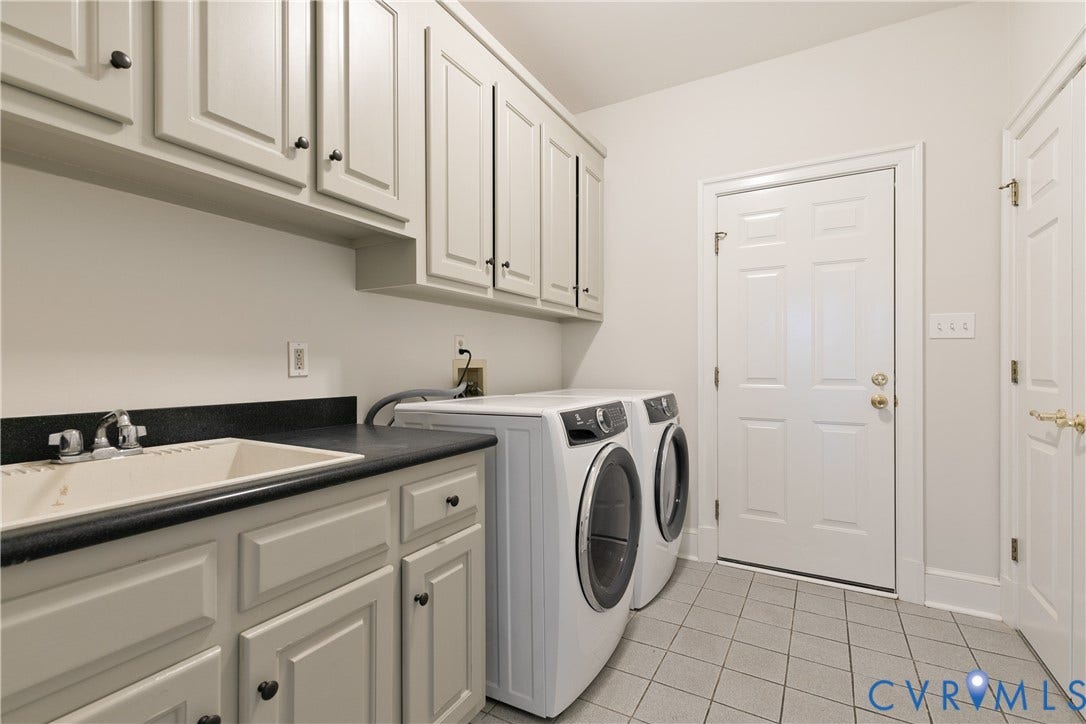 2621 Glenalmond Court, Powhatan, VA 23139 Built-in cabinetry with dark hardware, a utility sink with a chrome faucet, dark countertop, and tiled flooring