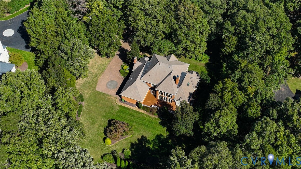 2621 Glenalmond Court, Powhatan, VA 23139 Expansive property featuring a multi-level roofline, brick exterior, and a spacious deck