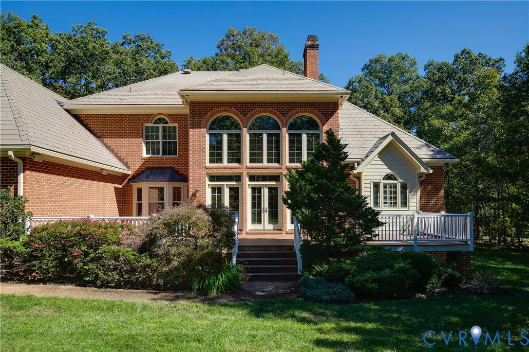 2621 Glenalmond Court, Powhatan, VA 23139 Brick exterior with multiple arched windows and a prominent chimney