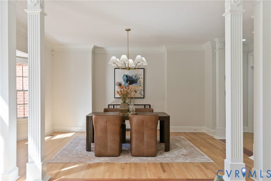 2621 Glenalmond Court, Powhatan, VA 23139 Hardwood flooring, decorative columns, window with brick exterior visibility, crown molding, and a chandelier