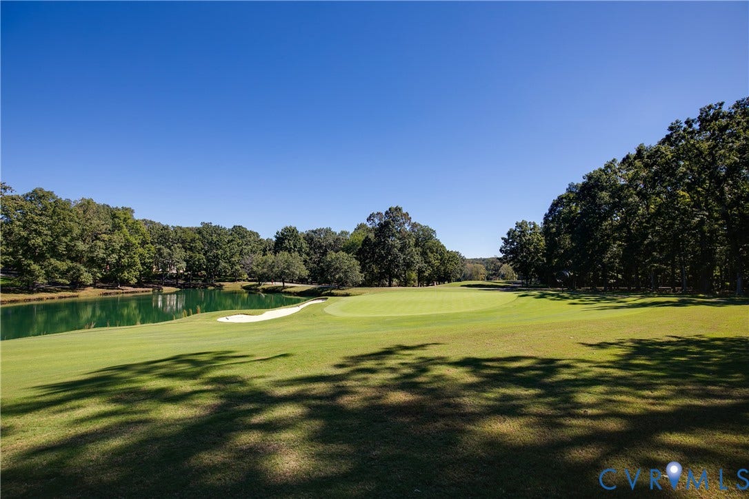 2621 Glenalmond Court, Powhatan, VA 23139 Expansive golf course setting featuring a manicured green, sand trap, and a tranquil water feature