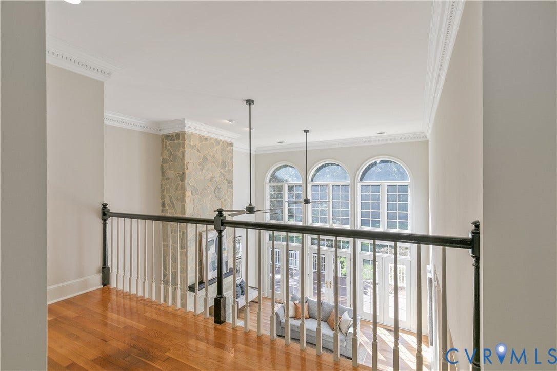 2621 Glenalmond Court, Powhatan, VA 23139 Hardwood flooring, wrought iron and wood railing, stone-clad fireplace, high ceilings, and arched windows