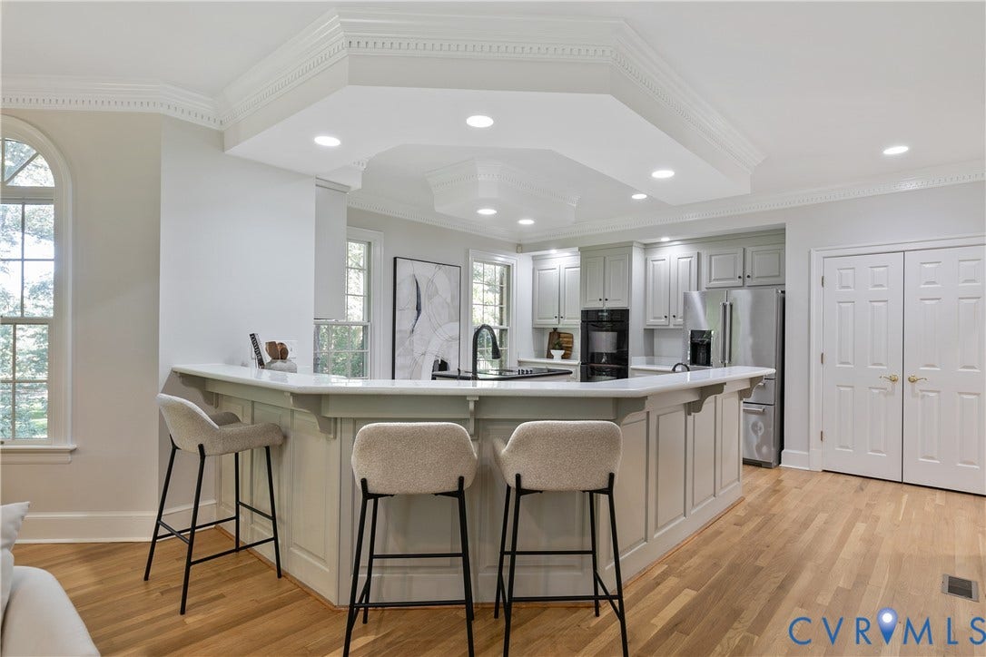 2621 Glenalmond Court, Powhatan, VA 23139 Kitchen with light wood-finish flooring, recessed lighting, white perimeter cabinetry, and a multi-level breakfast bar with a white countertop