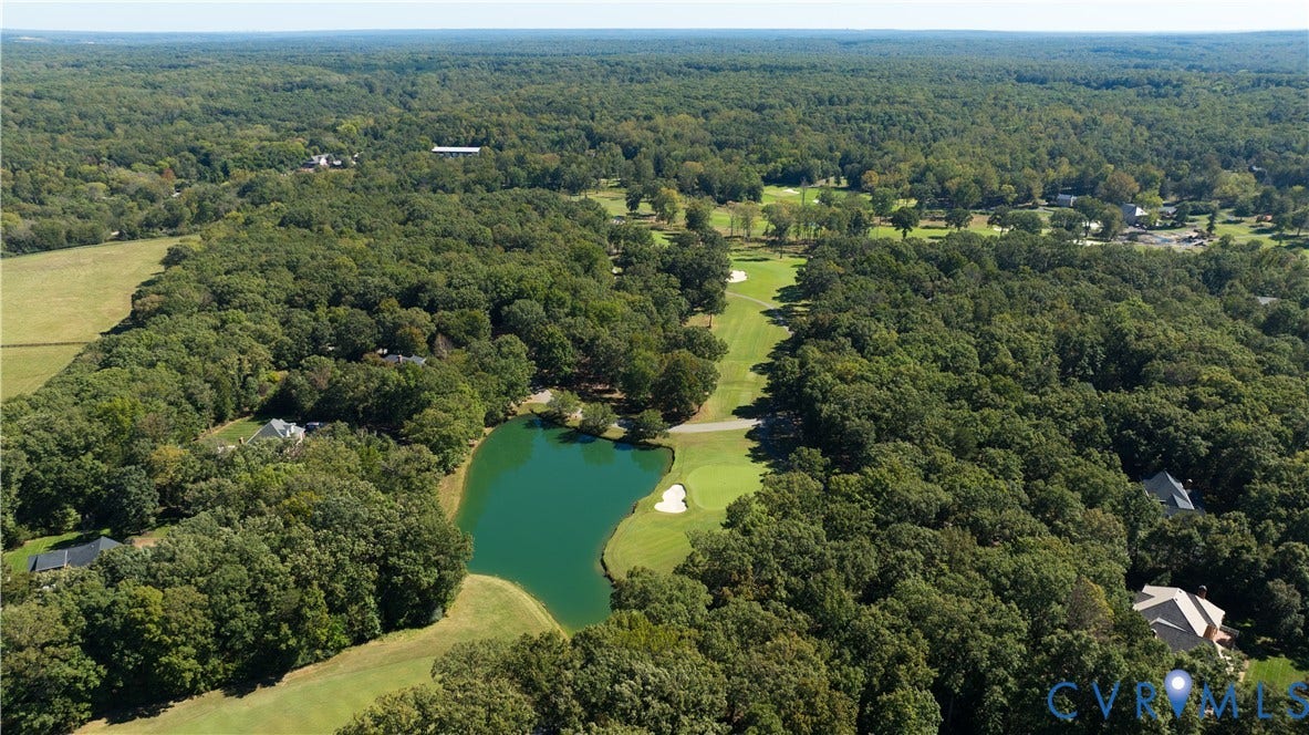 2621 Glenalmond Court, Powhatan, VA 23139 Expansive green landscape with a manicured golf course, surrounding dense tree coverage, and a prominent water feature