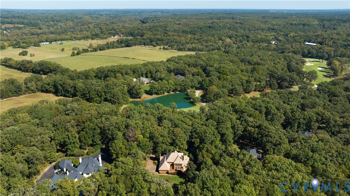 2621 Glenalmond Court, Powhatan, VA 23139 Expansive wooded acreage with a prominent golf course, a tranquil pond, and verdant fields