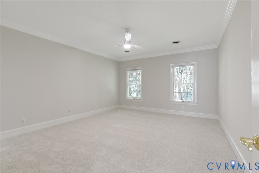 2621 Glenalmond Court, Powhatan, VA 23139 Spacious room featuring light-toned carpeting, crown molding, and two windows