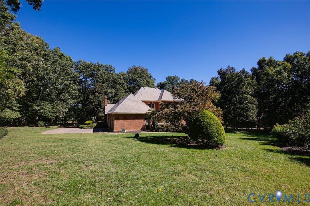 2621 Glenalmond Court, Powhatan, VA 23139 Brick exterior, shingle roof, mature trees, green lawn, paved driveway