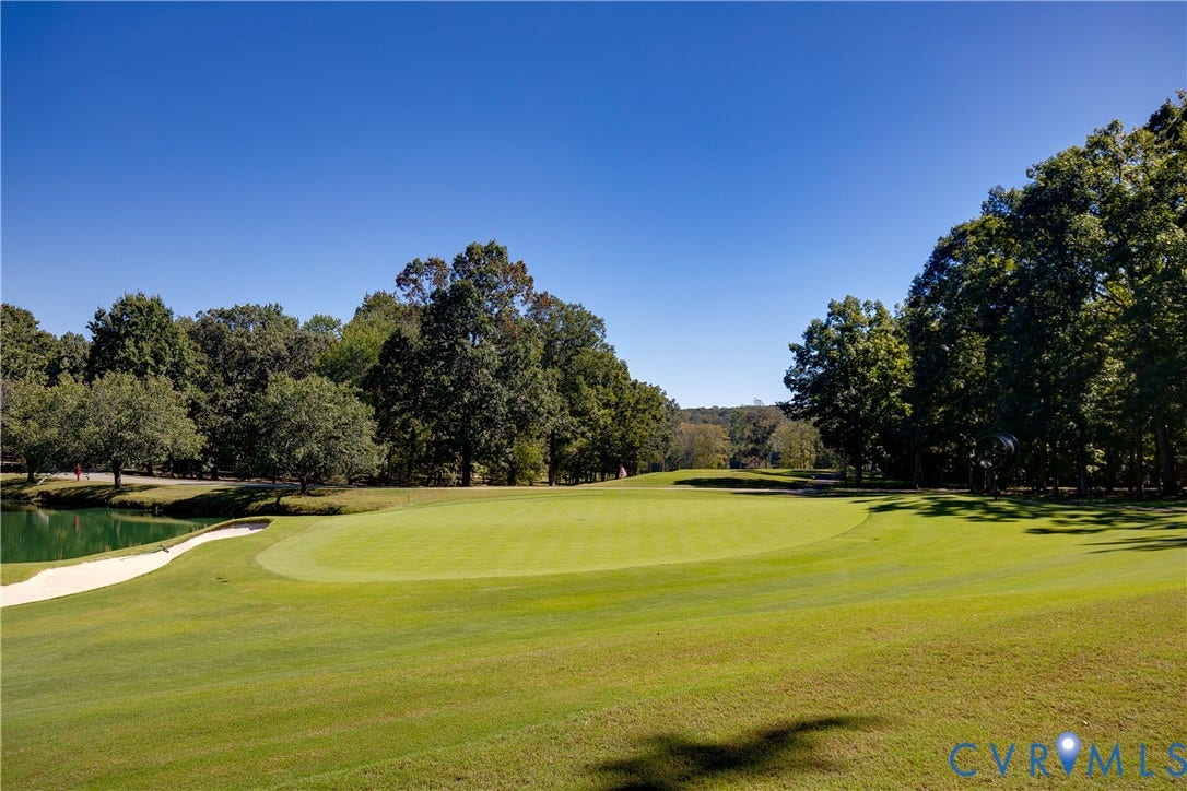 2621 Glenalmond Court, Powhatan, VA 23139 Expansive golf course green with a sand trap, water feature, and mature trees