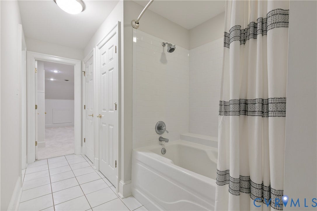 2621 Glenalmond Court, Powhatan, VA 23139 White tile flooring extending into a hallway with a flush mount light fixture