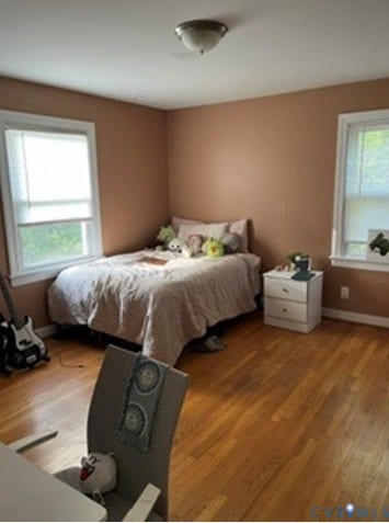 3732 Birdwood Road, Brookbury, Richmond, VA 23234 Room featuring warm-toned walls, two windows with white trim, and wood-finish flooring