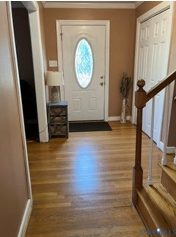 3732 Birdwood Road, Brookbury, Richmond, VA 23234 Entryway featuring wood-finish flooring, a white front door with an oval decorative glass insert, and a double-door closet