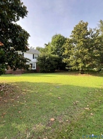 3732 Birdwood Road, Brookbury, Richmond, VA 23234 Spacious lawn area with mature trees and a partial view of the white exterior with dark shutters