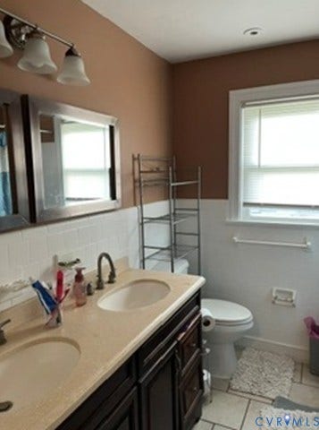 3732 Birdwood Road, Brookbury, Richmond, VA 23234 Dual vanity with undermount sinks and bronze-finish faucets set against a white subway tile backsplash