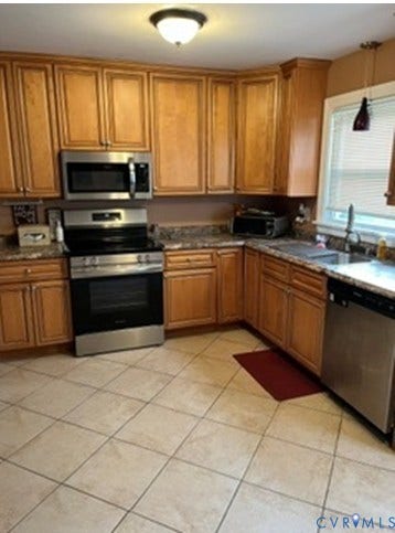 3732 Birdwood Road, Brookbury, Richmond, VA 23234 Kitchen featuring wood cabinetry, stainless steel appliances, speckled countertops, and neutral-toned tile flooring