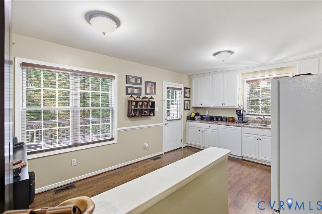 10624 Hamlin Drive, Hamlin Estates, Chester, VA 23831 Wood-finish flooring throughout, white cabinetry with dark hardware, a stainless steel sink, and light-colored countertops