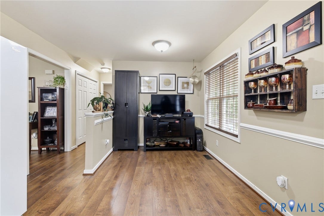 10624 Hamlin Drive, Hamlin Estates, Chester, VA 23831 Wood-finish flooring throughout, neutral wall paint, and a large window with blinds