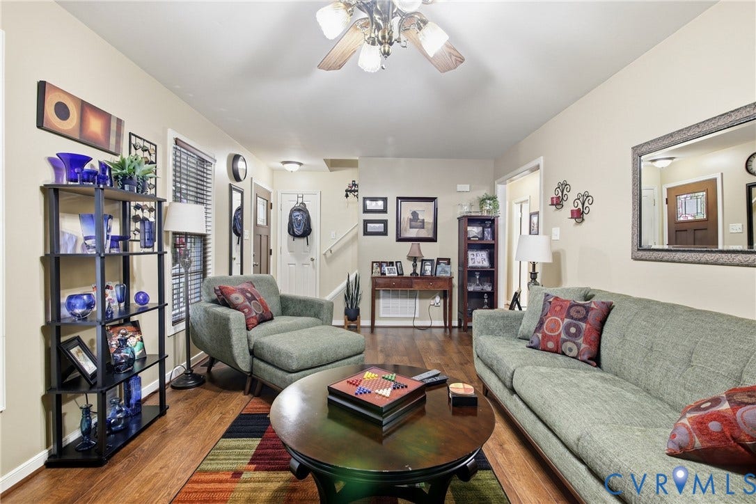 10624 Hamlin Drive, Hamlin Estates, Chester, VA 23831 1st floor - Wood-finish flooring throughout, ceiling fan with light fixture, built-in shelving, and a wall-mounted mirror with an ornate frame