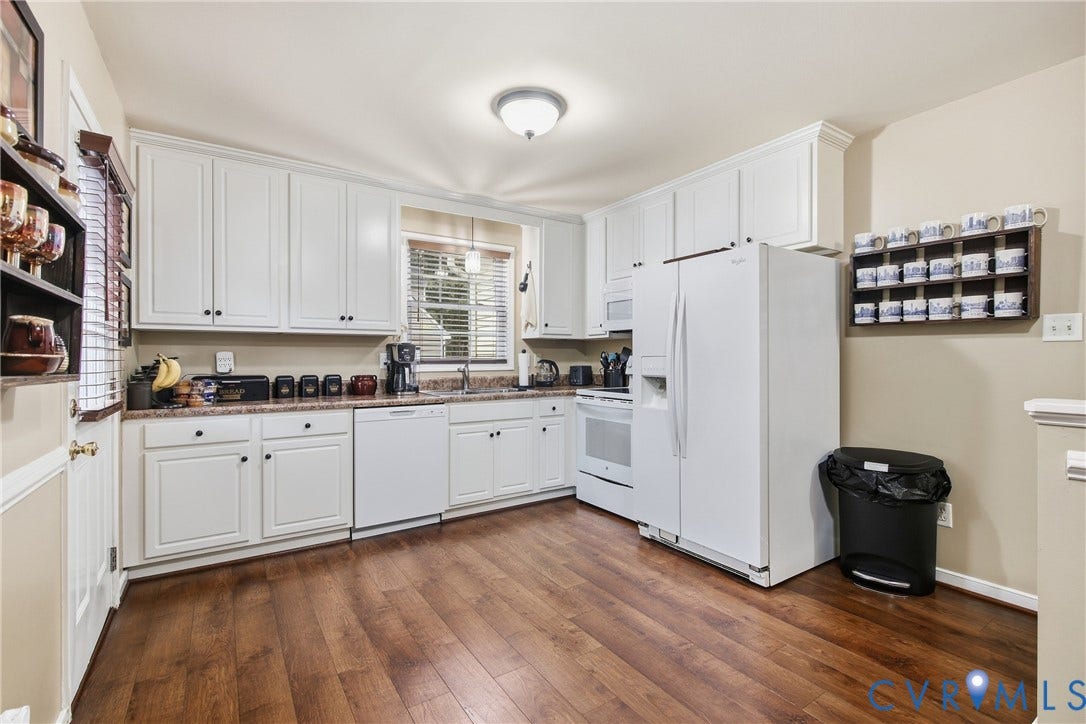 10624 Hamlin Drive, Hamlin Estates, Chester, VA 23831 Kitchen featuring wood-finish flooring, white cabinetry, integrated appliances, and a window with blinds