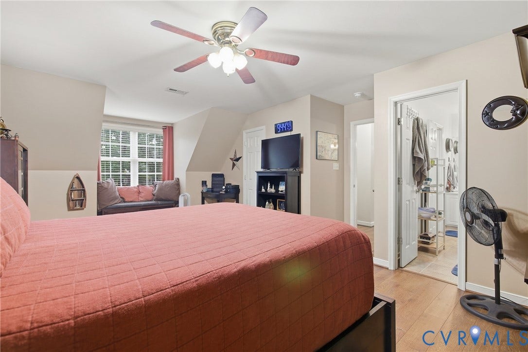 10624 Hamlin Drive, Hamlin Estates, Chester, VA 23831 Wood-finish flooring, ceiling fan with integrated lighting, window with blinds, and white trim throughout