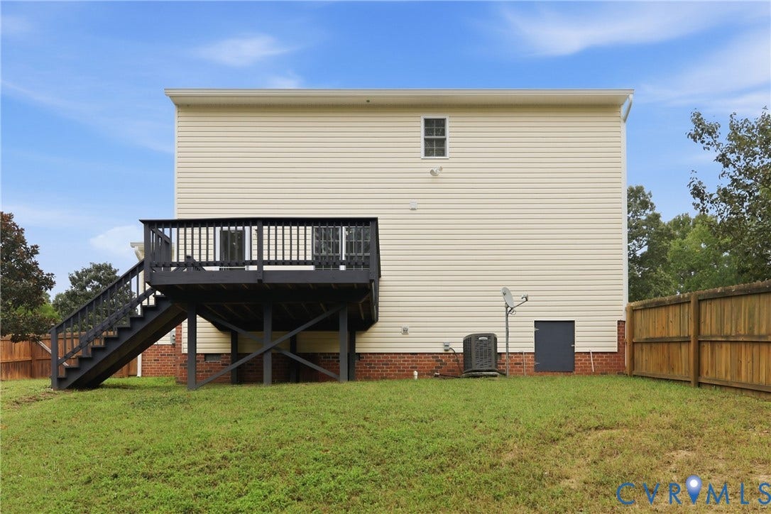 10624 Hamlin Drive, Hamlin Estates, Chester, VA 23831 Rear exterior with light-colored siding, red brick foundation, and a dark-painted wooden deck