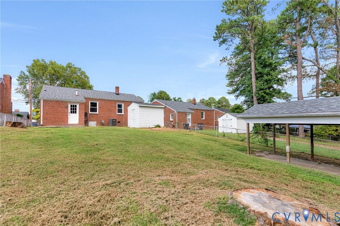 507 Walnut Avenue, Walnut Court, Colonial Heights, VA 23834 Red brick exterior, shingled roof, carport structure, detached storage shed, and mature trees