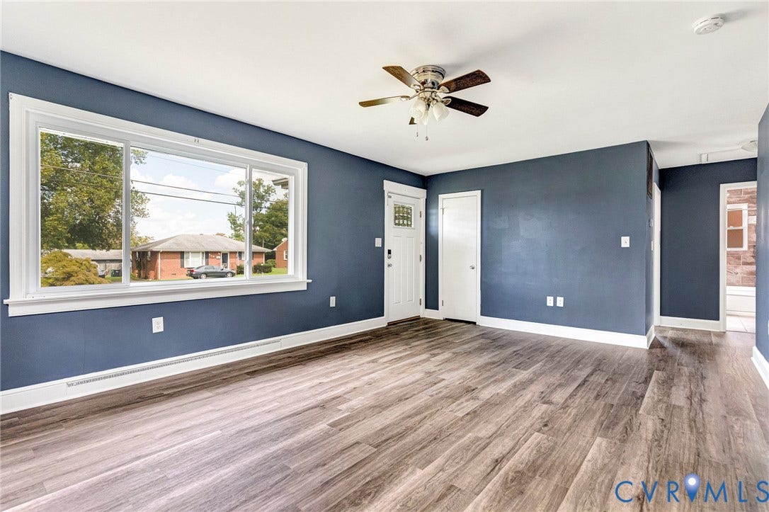 507 Walnut Avenue, Walnut Court, Colonial Heights, VA 23834 Spacious room featuring wood-finish flooring, a large window, a ceiling fan, and a white entry door with decorative glass inserts