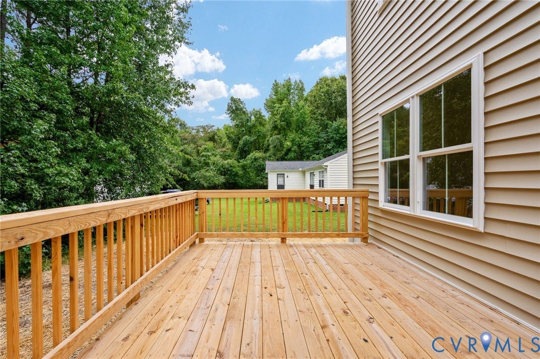 7603 Oster Drive, Chamberlayne Farms Area, Henrico, VA 23227 Spacious wooden deck with natural wood railing, light-colored siding, and large windows