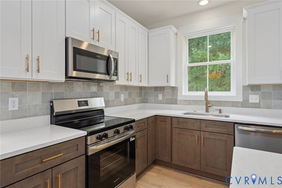 7603 Oster Drive, Chamberlayne Farms Area, Henrico, VA 23227 Two-tone cabinetry with white upper and wood-finish lower cabinets, stainless steel appliances, light-toned countertops, and a tiled backsplash