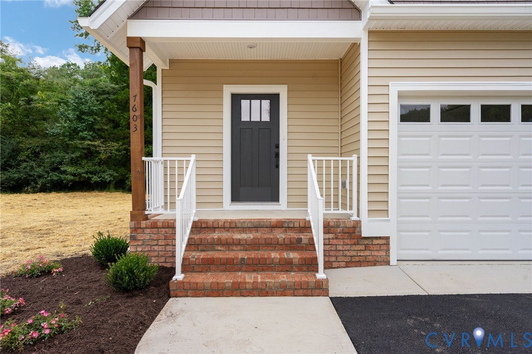 7603 Oster Drive, Chamberlayne Farms Area, Henrico, VA 23227 Inviting front entry with brick steps and white railings, featuring a dark panel door with window inserts, and light-colored siding