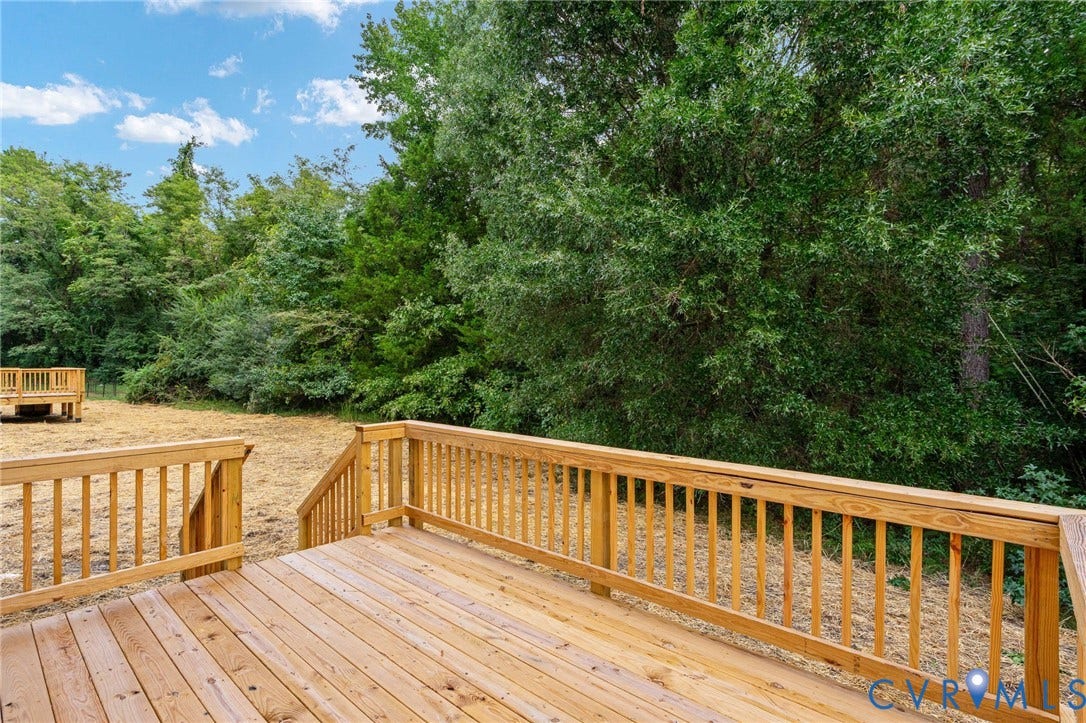 7603 Oster Drive, Chamberlayne Farms Area, Henrico, VA 23227 Expansive wood deck with railing, leading to a landscaped yard with mature trees