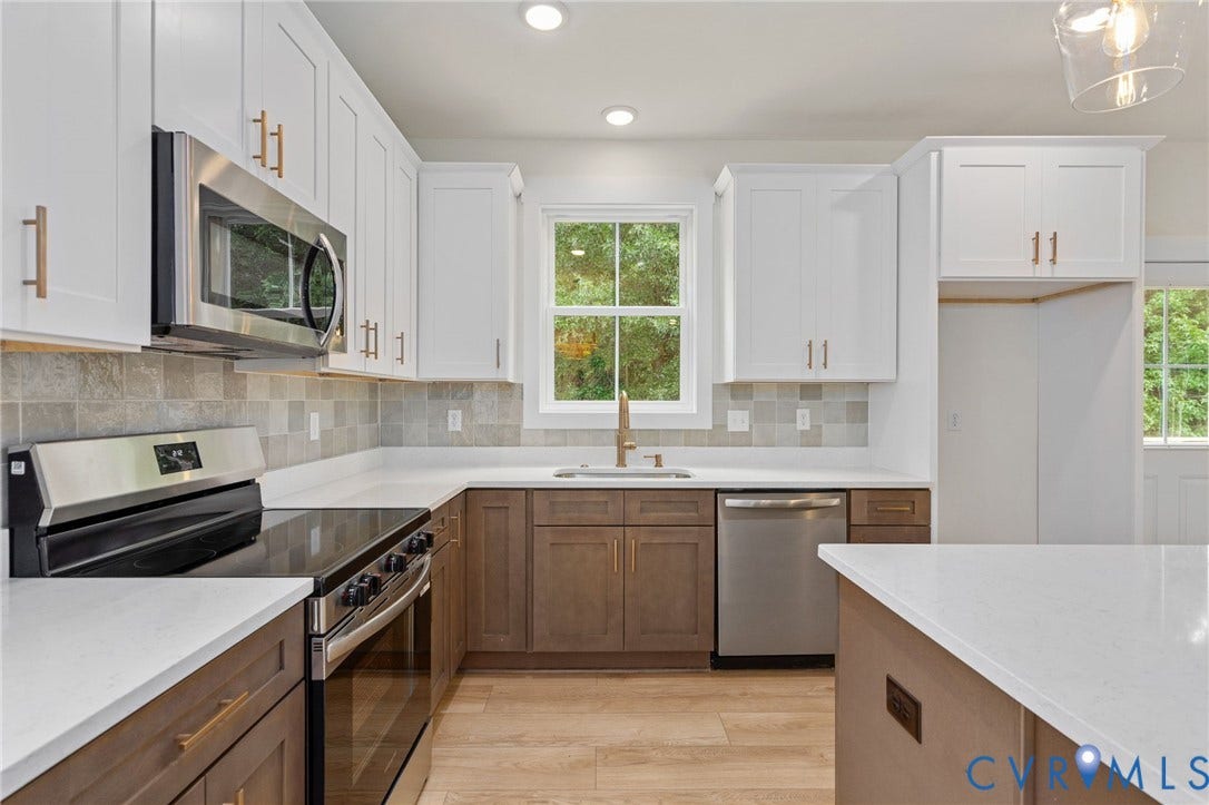 7603 Oster Drive, Chamberlayne Farms Area, Henrico, VA 23227 Kitchen featuring white upper cabinetry, wood-finish lower cabinetry, a stainless steel microwave, and white countertops