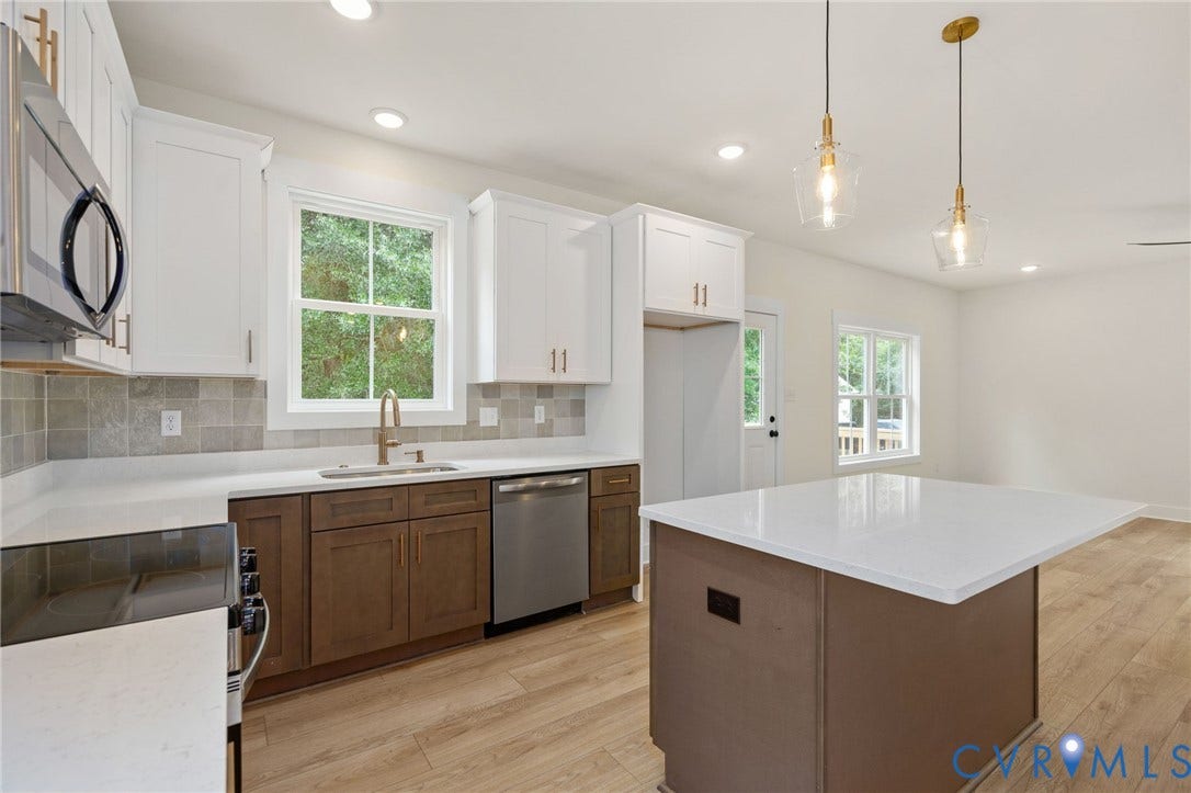 7603 Oster Drive, Chamberlayne Farms Area, Henrico, VA 23227 Kitchen featuring wood-finish flooring, recessed lighting, a kitchen island with a white countertop, and stainless steel appliances