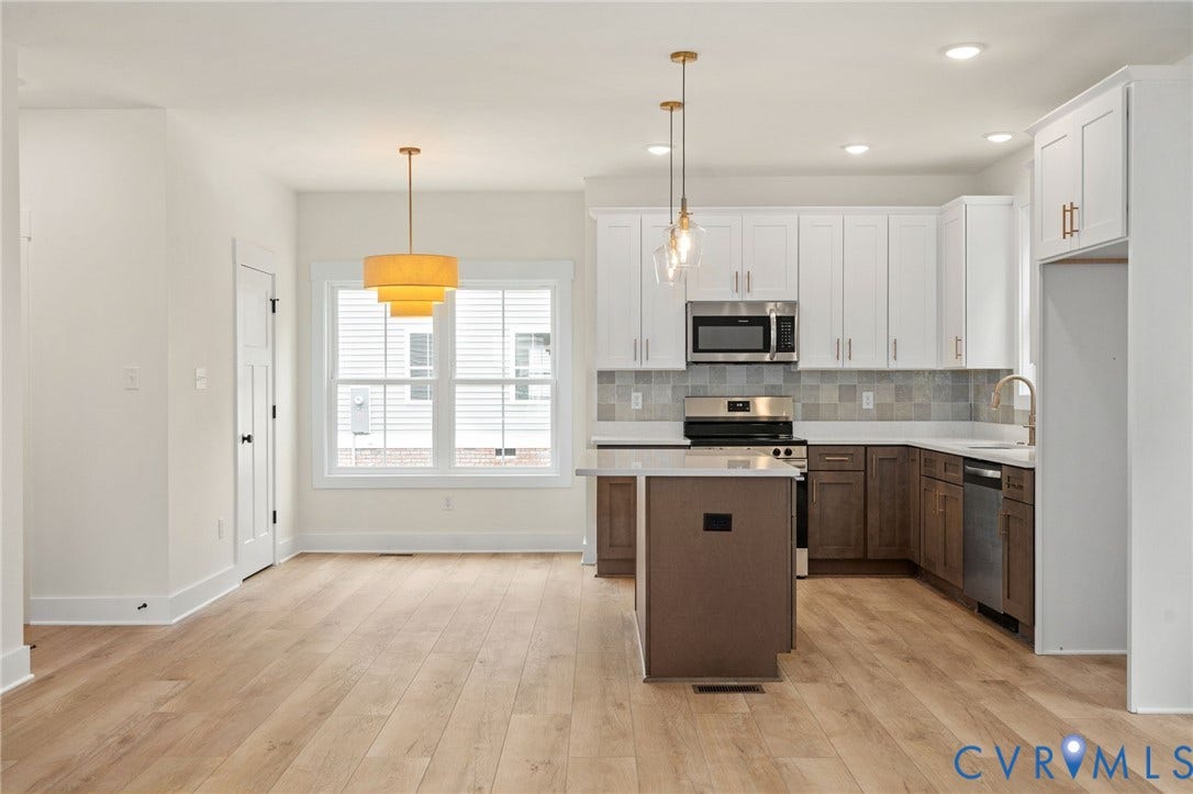 7603 Oster Drive, Chamberlayne Farms Area, Henrico, VA 23227 Wood-finish flooring, white cabinetry, stainless steel appliances, central island, and modern pendant lighting