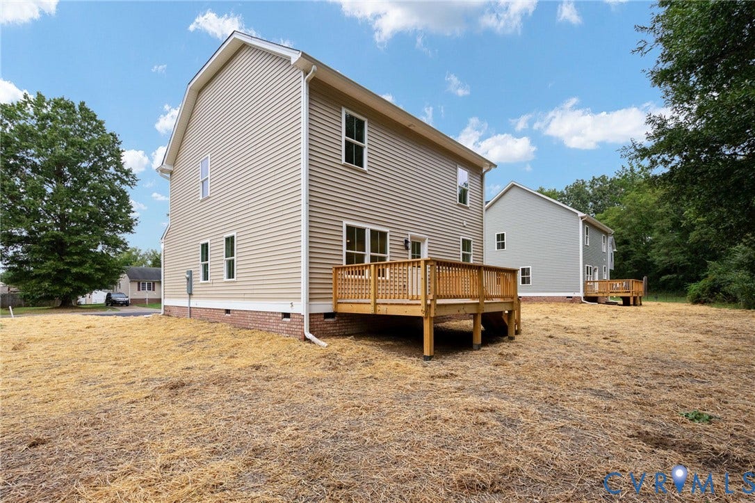 7603 Oster Drive, Chamberlayne Farms Area, Henrico, VA 23227 Rear exterior featuring a wood deck, beige horizontal siding, white trim, and a brick foundation