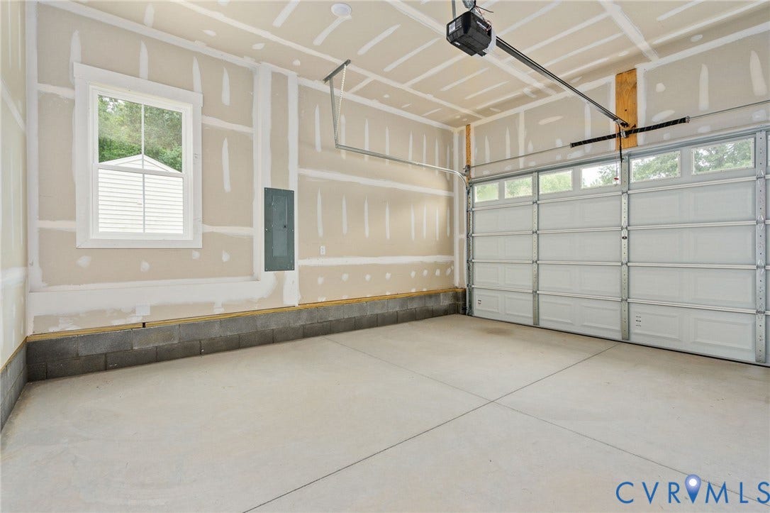 7603 Oster Drive, Chamberlayne Farms Area, Henrico, VA 23227 Concrete flooring with block foundation, overhead garage door with upper window panels, and an installed garage door opener