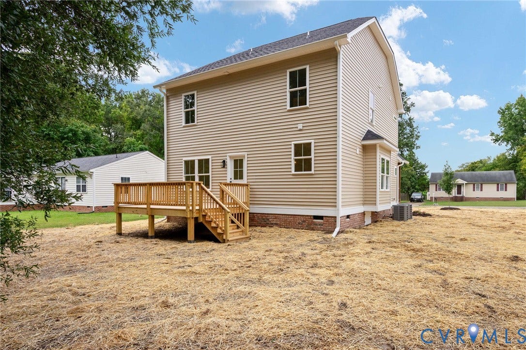 7603 Oster Drive, Chamberlayne Farms Area, Henrico, VA 23227 Rear exterior featuring a wooden deck with railing, siding facade, a side bay window, and visible HVAC unit
