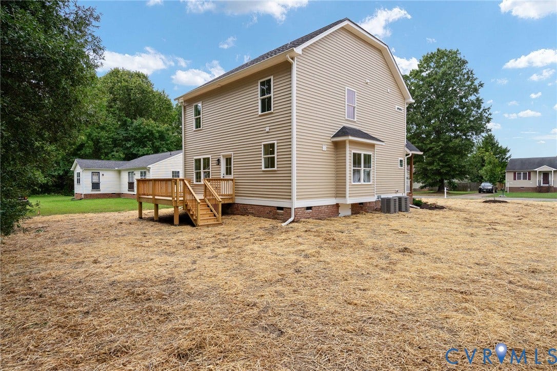 7603 Oster Drive, Chamberlayne Farms Area, Henrico, VA 23227 Light beige siding exterior, raised wood deck with stairs, multiple windows, bay window, and a gabled roof