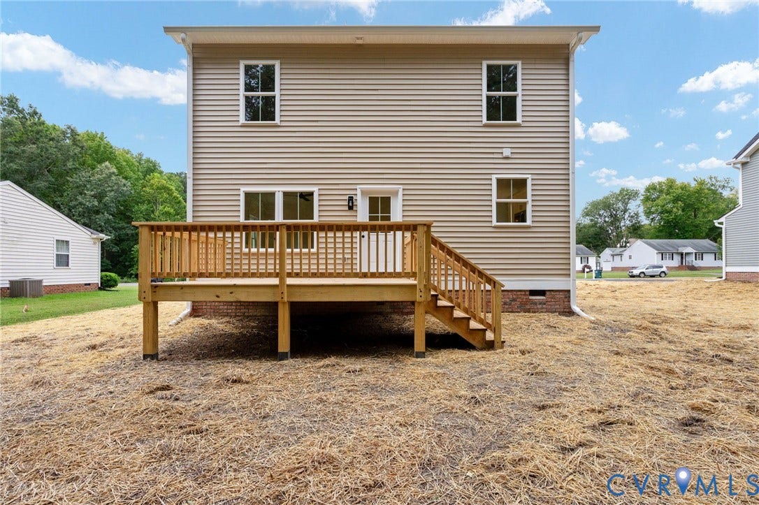 7603 Oster Drive, Chamberlayne Farms Area, Henrico, VA 23227 Rear exterior featuring beige siding, multiple windows, and a wood deck with stairs