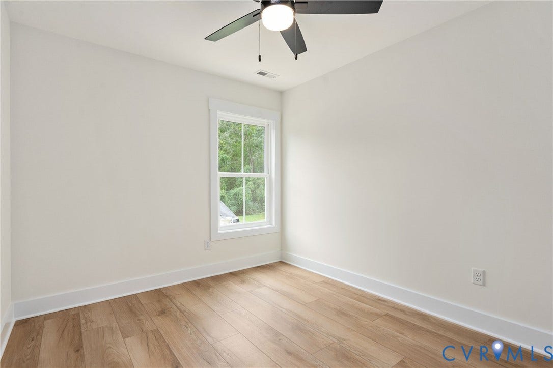 7603 Oster Drive, Chamberlayne Farms Area, Henrico, VA 23227 Light-filled room featuring a ceiling fan, wood-finish flooring, a white trim window, and neutral wall paint