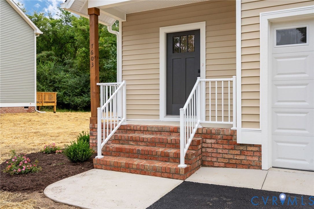 7603 Oster Drive, Chamberlayne Farms Area, Henrico, VA 23227 Front entry with brick steps, white railing, dark panel door, and an attached garage
