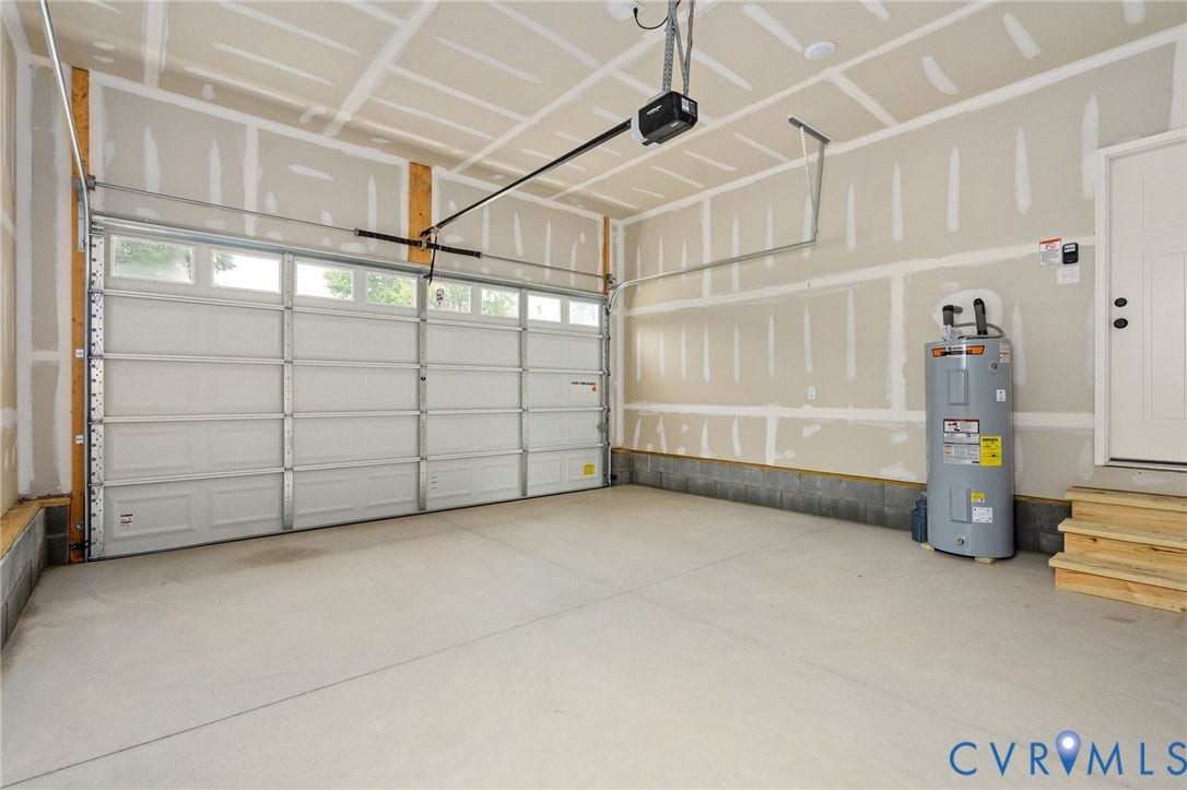 7603 Oster Drive, Chamberlayne Farms Area, Henrico, VA 23227 Attached garage with a concrete floor, automatic garage door opener, and a panel-style garage door featuring upper window lites